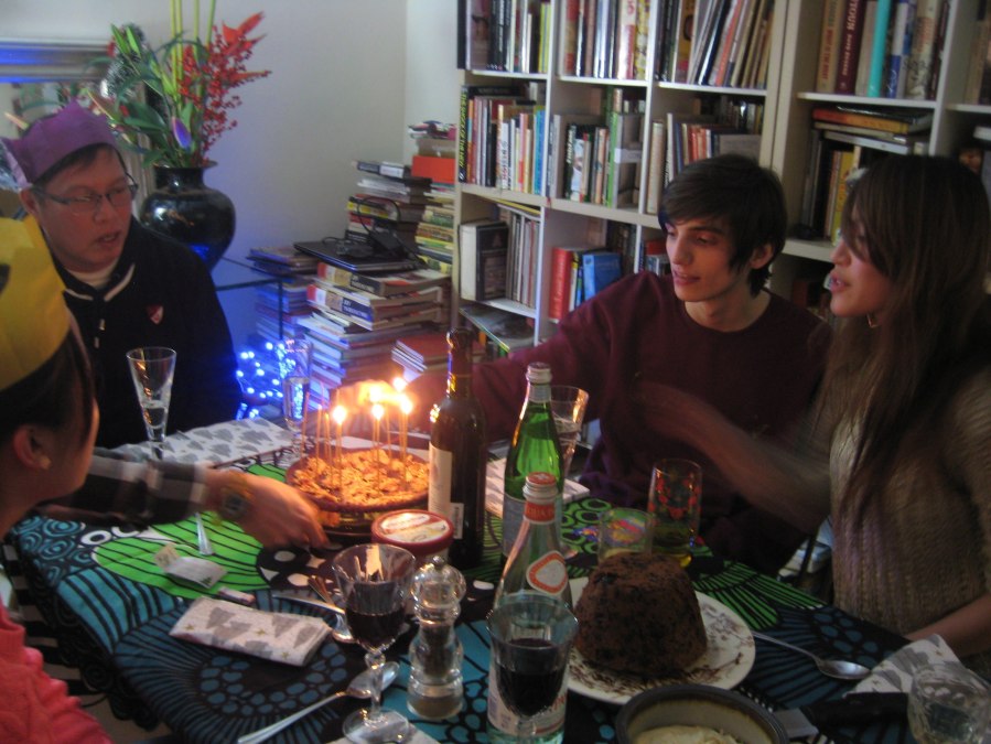 dinner table with lit candles, cosy but colourful