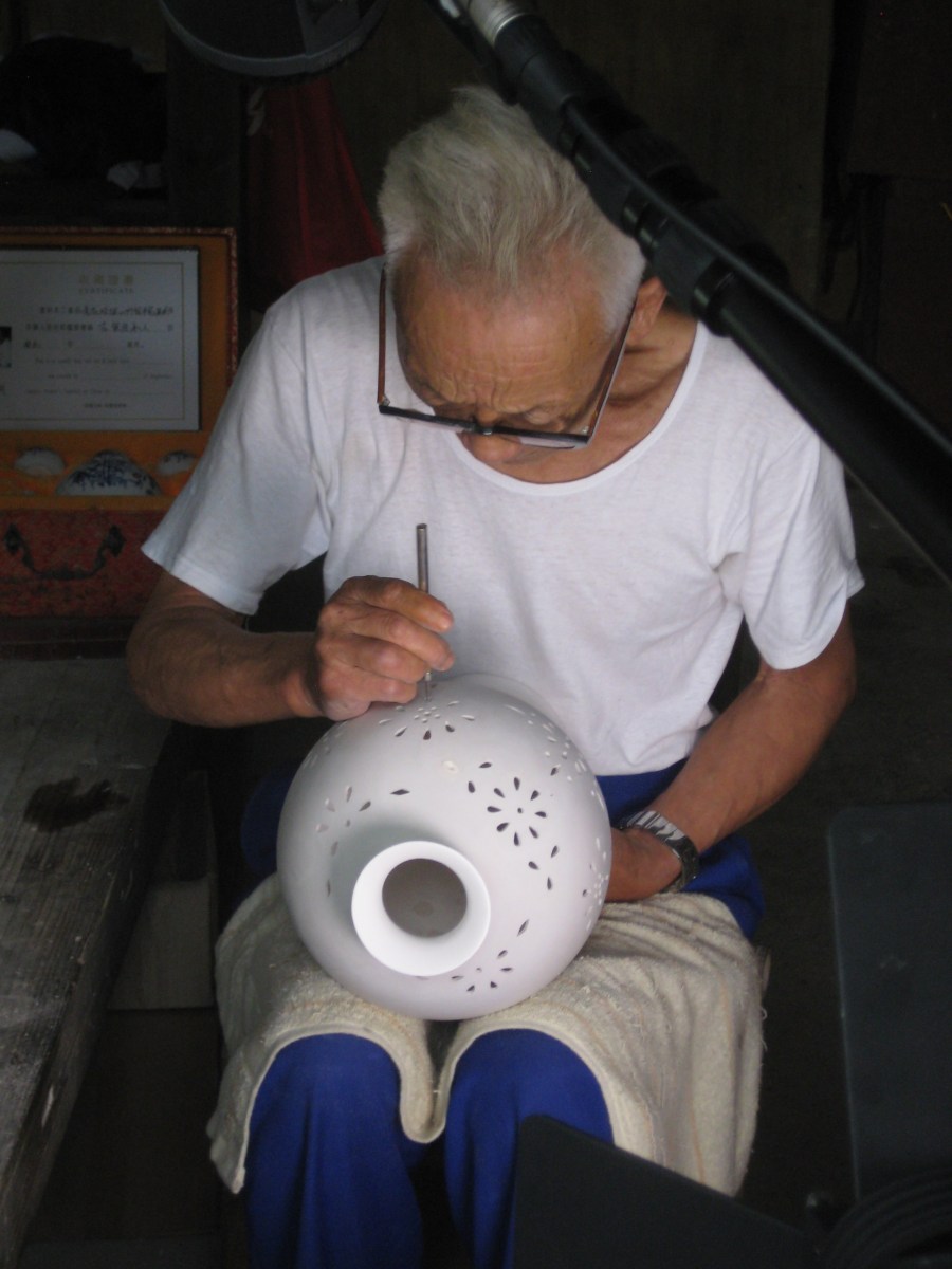 At the ancient kiln museum all the workers are [sorry!] ancient. Here is a carving demonstration, this pot has not been fired so this is a very skilled job, hence the age perhaps.