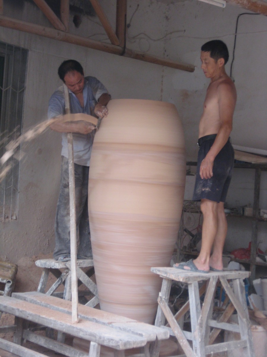 making giant pots, connecting sections requires a team of workers [usually topless men with cigarettes]